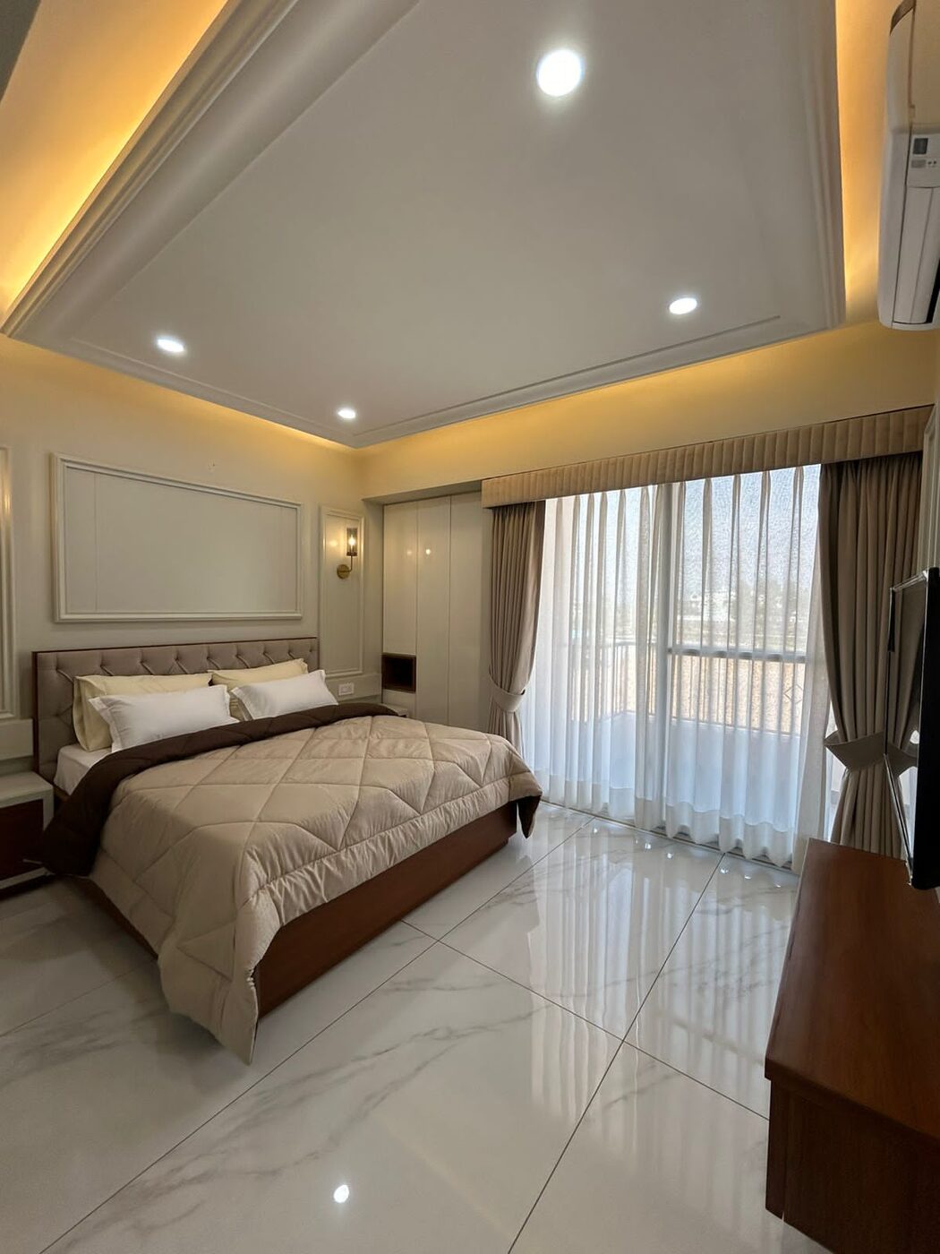 Bedroom with balcony glazing in the furnished sample flat at Absolute Residency, Sector 92 Mohali
