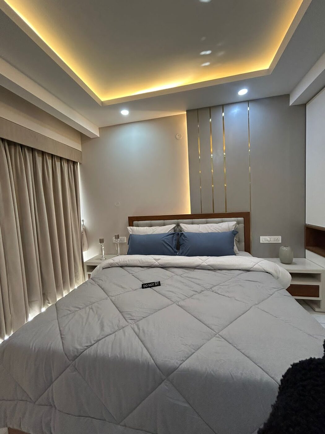 Bedroom with a fluted wall panel behind the bed and bedside tables — Absolute Residency, Sector 92 Mohali