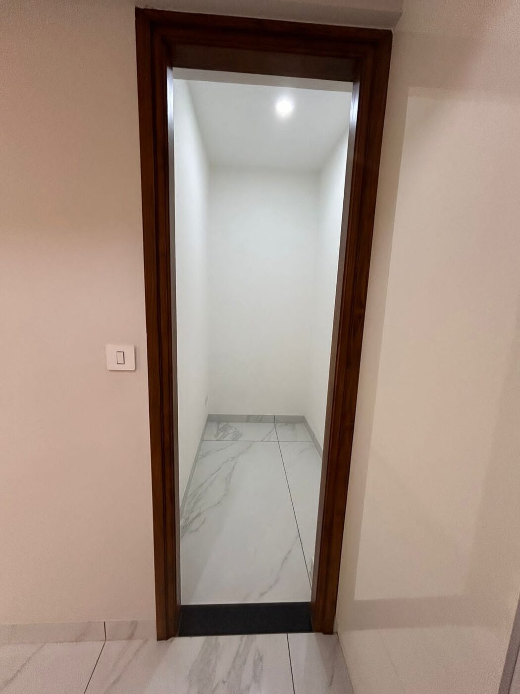 Doorway into a small tiled utility or store room — Absolute Residency, Sector 92 Mohali