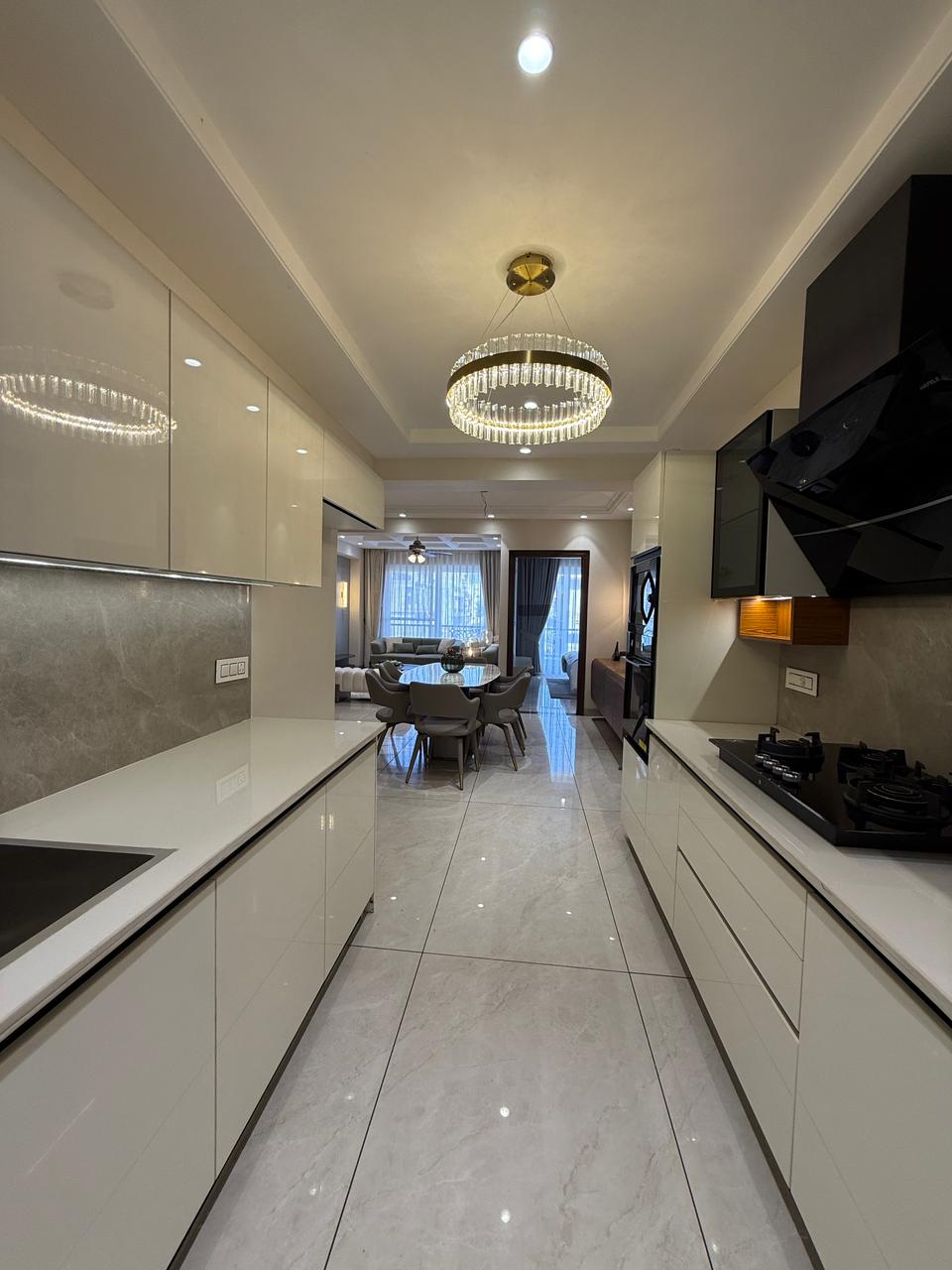 Modular kitchen with breakfast counter and chimney — The Grandeur, Sector 117 Mohali