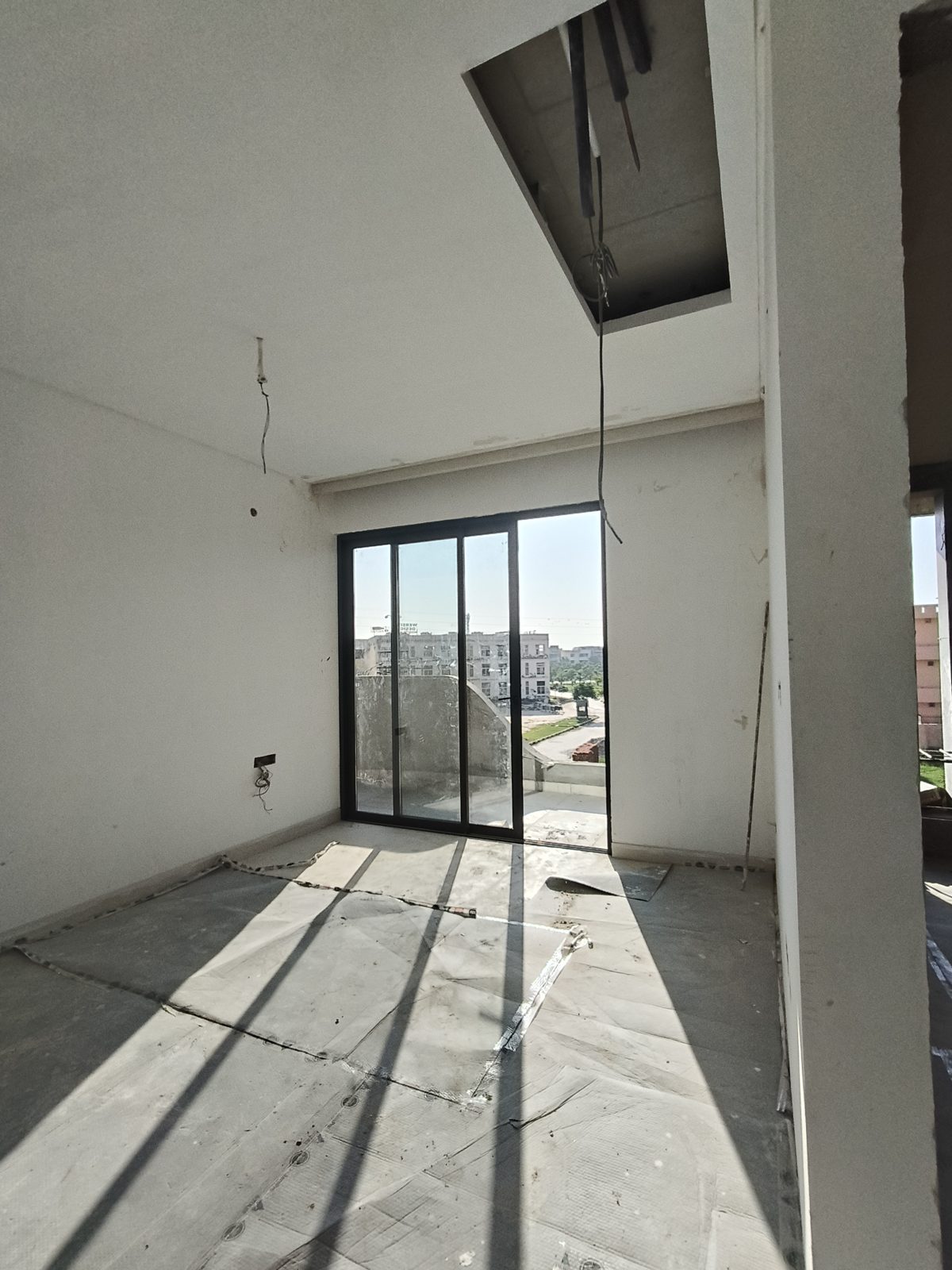 Sample flat room with three-panel sliding door, October 2026