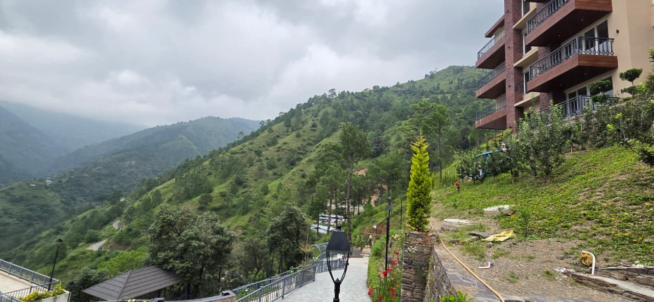Apartment block on a landscaped hillside above a valley — Himachal Pradesh
