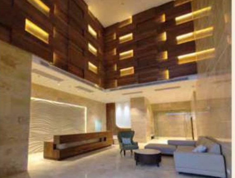 Double-height lobby with timber-panelled wall, Torre Alta Mohali